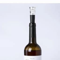 A drink bottle with a dark brown body and a clear top, featuring a black neck and a transparent spout.