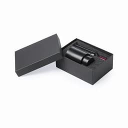 A drink bottle in a black gift box with foam padding, featuring a sleek design and a logo.