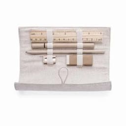 A stationery set featuring a ruler, pencils, an eraser, and a sharpener, all secured in a light-coloured pouch.