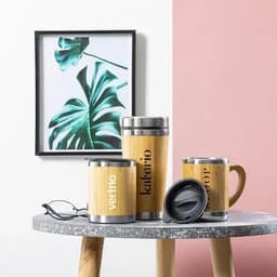 A collection of bamboo and stainless-steel drink containers in various styles, with a framed botanical print in the background.