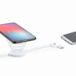 A wireless phone charger with a spiral design, featuring a USB-C cable and a smartphone placed above it.
