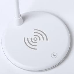 A white wireless charging pad with a circular base and a power button. It features a logo and a signal design.