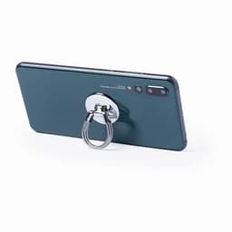 A smartphone with a green back and a silver ring holder attached. The device features a camera on one side.