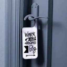 A door hanger featuring a white background with black text and graphics, promoting motivation and positivity.