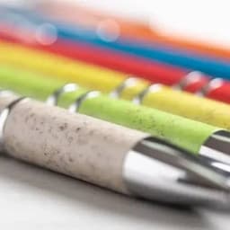A set of colourful pens featuring green, yellow, red, blue, and grey caps, with a shiny metallic tip and grip.