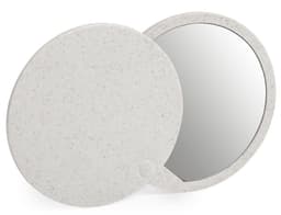A compact mirror with a speckled white exterior, featuring a round design and a reflective surface.