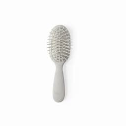 A hairbrush with a grey handle and a rounded paddle, featuring flexible bristles and a vented design.