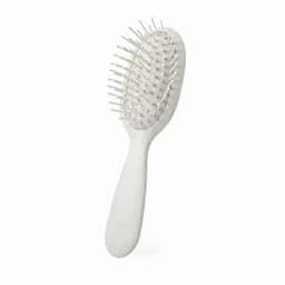 A hairbrush with a white handle and white bristles, featuring a rounded design and flexible base.