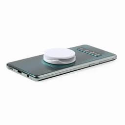 A phone with a circular magnetic accessory on its back. The phone is a gradient green colour.