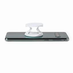 A phone stand in white, placed on the back of a sleek smartphone. The device has a simple, minimalist design.
