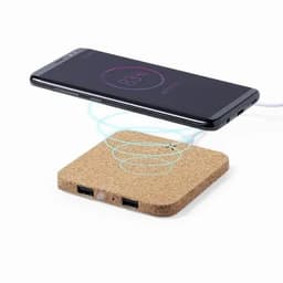 A wireless charger with a cork base and two USB ports, featuring a phone above it showing charging status.