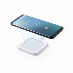 A wireless charging pad in white with a smartphone hovering above it, displaying a charging icon on the screen.
