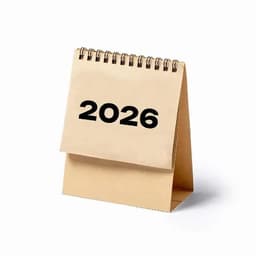 A tabletop calendar displaying the year 2026, featuring a spiral binding and a neutral colour scheme.