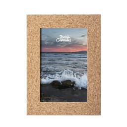 A cork-framed picture displaying a scenic view of ocean waves at sunset. The frame features a natural brown colour.