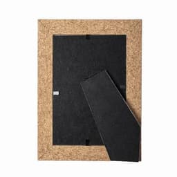 A cork photo frame with a removable backing, featuring a black interior and a natural cork border.