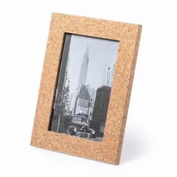 A cork photo frame displaying a black and white image of a city skyline. The frame has a natural textured finish.