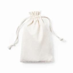 A drawstring pouch in cream colour, with a textured surface and two fabric ties on top. Contains no visible items.
