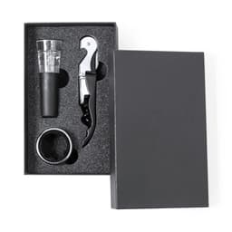 A gift box containing a corkscrew, wine pourer, and a ring, all set against a black background.