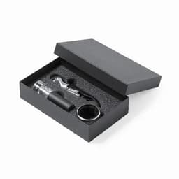 A wine accessory gift set in a black box, featuring a corkscrew, wine pourer, and a bottle stopper.