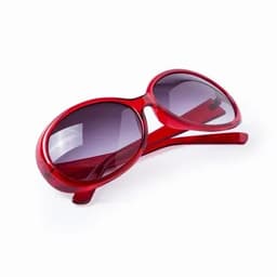 A pair of red sunglasses with dark lenses, featuring a smooth design and curved frames.