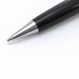 A black pen with a silver tip and sleek design. The pen has a smooth surface and a polished finish.