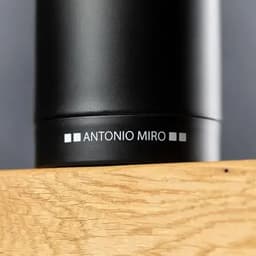A drink bottle in matte black with a sleek design, featuring a branding logo on the side.