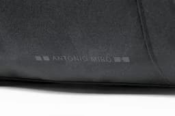 A black promotional bag featuring a subtle logo or branding from Antonio Miro.
