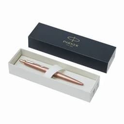 A rose gold pen in a white box with a black outer sleeve, featuring a logo on the lid.