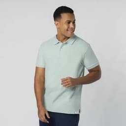 A light green adult polo shirt featuring a collar and short sleeves. The model is smiling while posing.
