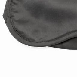A grey sleep mask with a smooth fabric surface and a stitched edge. It has a simple, understated design.