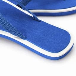 A pair of blue flip-flops featuring a textured strap and white detailing on the sole.