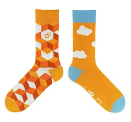 A pair of socks featuring an orange geometric design on one and a cloud pattern on the other, with blue accents.