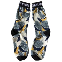 A pair of 3D printed dress socks featuring a vibrant citrus pattern in yellow, navy, and black.