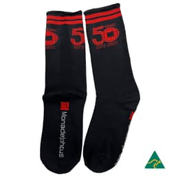Black bamboo work socks with red detailing and branding, featuring a commemorative "50 Years" design.