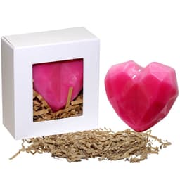 A heart-shaped pink soap presented in a white box, with shredded paper inside and around it.