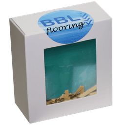 A gift box containing a teal drink bottle with light wood shavings inside, featuring a logo on the lid.