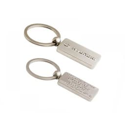 A silver 3D metal key ring featuring a rectangular design with a logo on one side and smooth on the other.