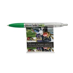 A pen with a transparent body features a green cap and a small flag/banner attached, displayed on a flat surface.