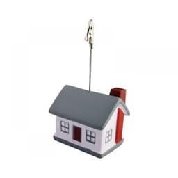 A house-shaped note holder in red, white, and grey, featuring a clip and a metal wire for holding notes.