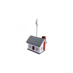 A house-shaped note holder in grey, red, and white with a clip for holding notes. It has a chimney and window details.