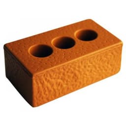A stress brick in orange with a textured surface and three circular indentations on top.