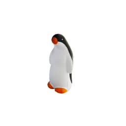 A stress toy in the shape of a penguin, featuring black and white colours with orange feet and beak.