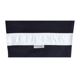 A close-up of navy work pants featuring a reflective white strip and a branded label.