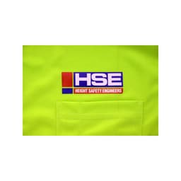 A bright yellow polo shirt featuring a pocket and a logo for a company related to height safety engineering.