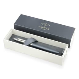 A matte grey ballpoint pen displayed in a white box with a black interior, featuring a logo.