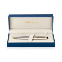 A brushed stainless steel ballpoint pen with gold accents, presented in a blue box with a soft interior.