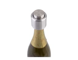 A drink bottle featuring a silver champagne stopper on top, with an ornate label partially visible on the neck.