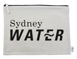 A cream-coloured conference bag with a black logo featuring the words "Sydney WATER" and a zipper closure.