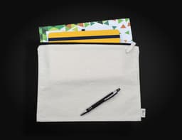 A cream-coloured conference bag featuring a zip closure, with a pen and assorted notepads visible inside.