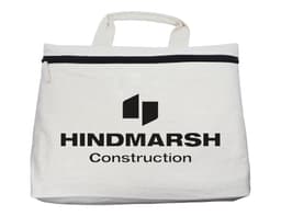 A cream conference bag with a top zip closure and a handle, featuring a logo on the front.